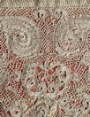 Lot 324 - A lace trimmed salmon pink bearing cloth,...