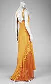 Lot 478 - A Gianni Versace tangerine crand lace evening...