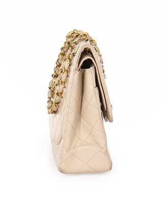 Lot 14 - A Chanel quilted beige leather handbag, 1980s,...