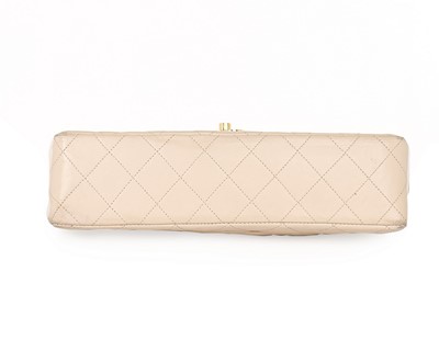 Lot 14 - A Chanel quilted beige leather handbag, 1980s,...