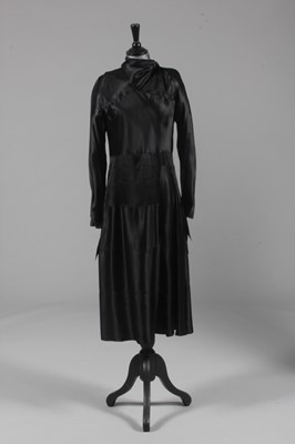 Lot 125 - A black satin dinner gown, attributed to...
