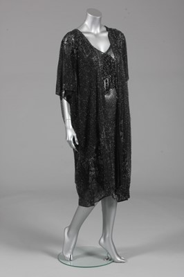 Lot 126 - A black beaded dress and evening coat, late...