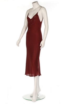 Lot 207 - Audrey Hepburn's Givenchy burgundy bias-cut...