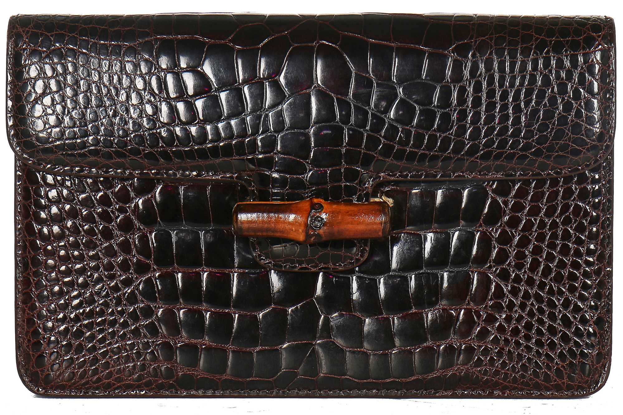 Lot 10 - A Gucci brown crocodile clutch bag with bamboo lift-clasp, early 1970s