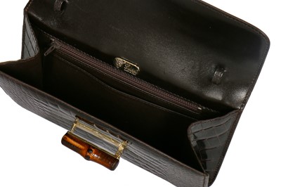 Lot 10 - A Gucci brown crocodile clutch bag with bamboo lift-clasp, early 1970s