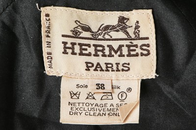Lot 148 - An Hermès black satin evening coat/robe, 1990s,...