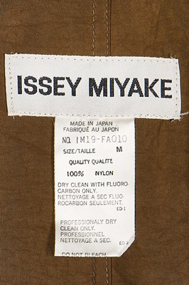 Lot 279 - An Issey Miyake ensemble, comprising: green-grey nylon crêpe coat, Spring-Summer 1991