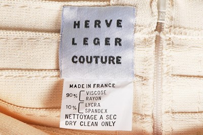 Lot 185 - An Hervé Léger ivory bandage evening gown,...