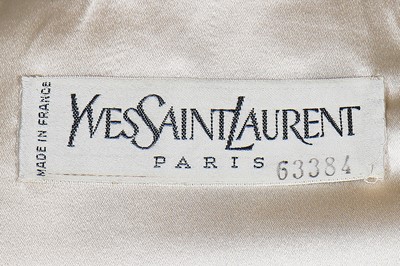 Lot 179 - An Yves Saint Laurent couture ivory satin evening jacket, probably Spring-Summer 1988