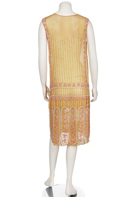 Lot 5 - A beaded mustard muslin flapper dress, mid-1920s
