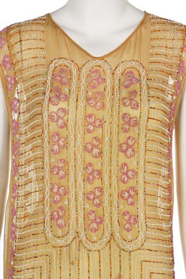 Lot 5 - A beaded mustard muslin flapper dress, mid-1920s