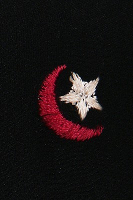Lot 144 - An Ossie Clark moon and stars embroidered black moss crêpe dress, circa 1970