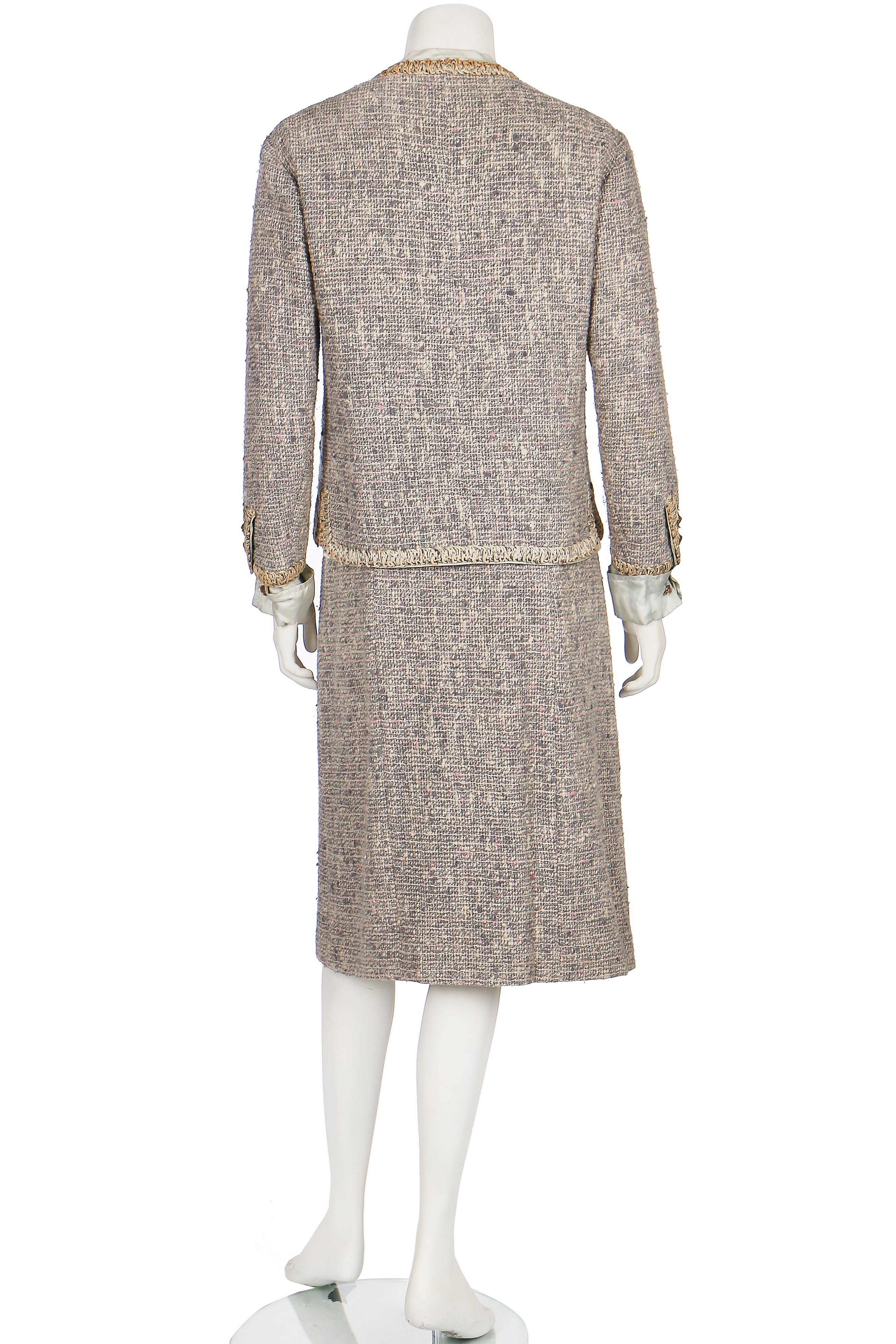 Lot 17 - A Chanel couture grey-pink tweed suit, 1960,