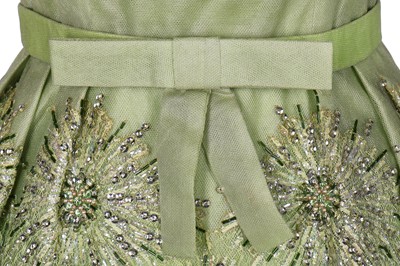 Lot 108 - A Norman Hartnell couture pale green sequinned tulle cocktail dress, circa 1960