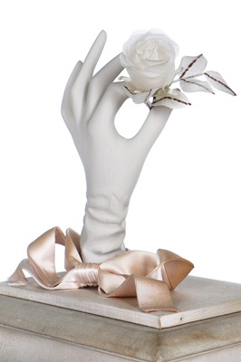 Lot 107 - A Christian Dior shop display of a mounted and encased gloved hand holding a rose, 1950s