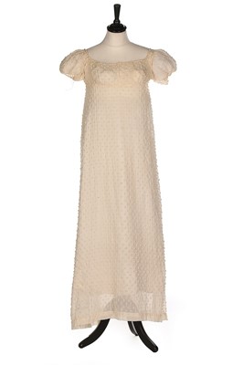 Lot 83 - A white muslin empire line dress, circa 1805,...