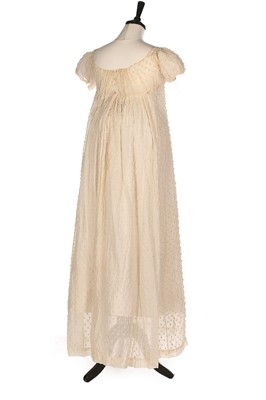 Lot 83 - A white muslin empire line dress, circa 1805,...