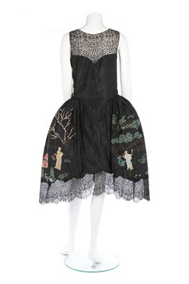 Lot 107 - A Chinoiserie embroidered black taffeta robe...