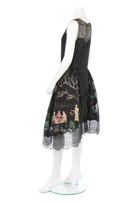 Lot 107 - A Chinoiserie embroidered black taffeta robe...