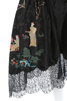 Lot 107 - A Chinoiserie embroidered black taffeta robe...