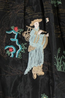 Lot 107 - A Chinoiserie embroidered black taffeta robe...