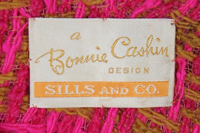 Lot 110 - A Bonnie Cashin for Sills shocking-pink and mustard-yellow woven checked wool poncho, 1960s