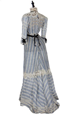 Lot 19 - A floral printed blue and white striped cotton gown, circa 1905