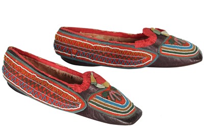 Lot 353 - A rare pair of lady's shoes, applied with native American beaded moccasin panels, French, dated 1848