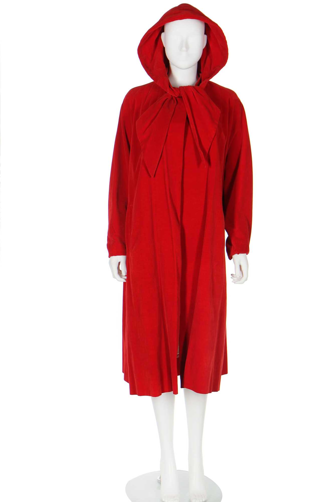 Lot 91 - A Schiaparelli red velvet swing-coat with hood, late 1950s
