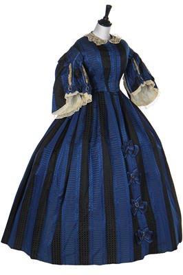 Lot 272 - A gown of figured silk in bold blue and black stripes, late 1850s