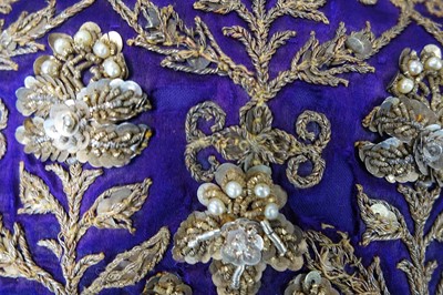 Lot 276 - A boy's elaborately embroidered and bejewelled purple satin waistcoat, Indian, late 19th century