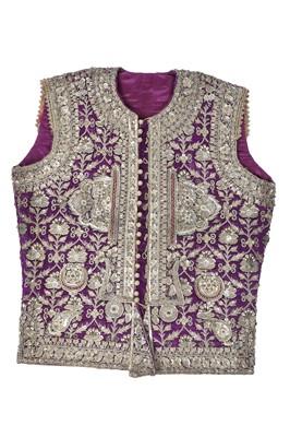 Lot 276 - A boy's elaborately embroidered and bejewelled purple satin waistcoat, Indian, late 19th century
