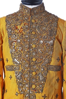 Lot 273 - A young man's brilliant yellow silk court coat, Indian, 1910-20