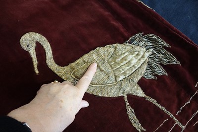 Lot 237 - A burgundy velvet robe appliquéd with large gilt-thread embroidered cranes amongst lily pads, Japanese, probably 1910s