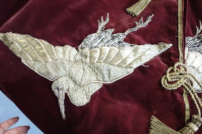 Lot 237 - A burgundy velvet robe appliquéd with large gilt-thread embroidered cranes amongst lily pads, Japanese, probably 1910s