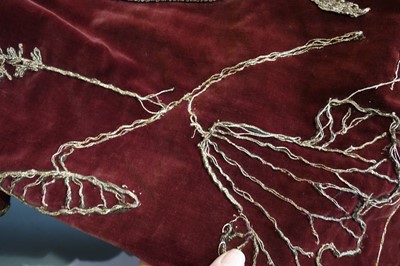 Lot 237 - A burgundy velvet robe appliquéd with large gilt-thread embroidered cranes amongst lily pads, Japanese, probably 1910s