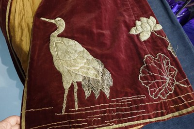 Lot 237 - A burgundy velvet robe appliquéd with large gilt-thread embroidered cranes amongst lily pads, Japanese, probably 1910s