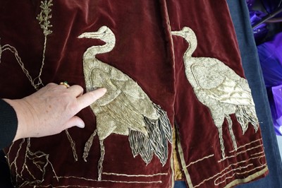 Lot 237 - A burgundy velvet robe appliquéd with large gilt-thread embroidered cranes amongst lily pads, Japanese, probably 1910s