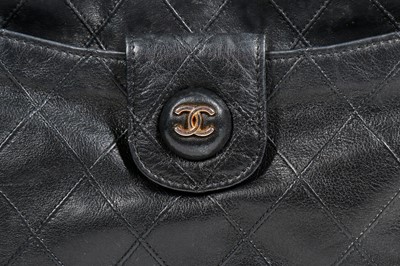 Lot 13 - A Chanel quilted black lambskin leather pochette, 1986-88