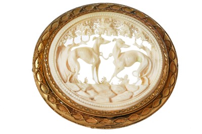 Lot 30 - A finely-carved ivory brooch set in a gilt mount, probably French, 1860s-80s