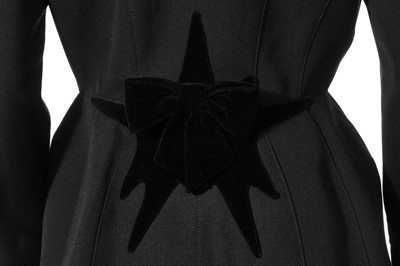 Lot 122 - A Thierry Mugler black wool suit with velvet 'starburst' and bows, late 1980s-early 1990s