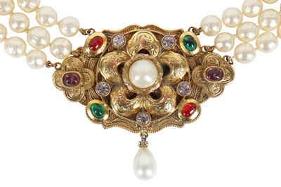 Lot 13 - A fine Chanel three-strand 'pearl' necklace with bejewelled gilt plaquette, 1971-1981