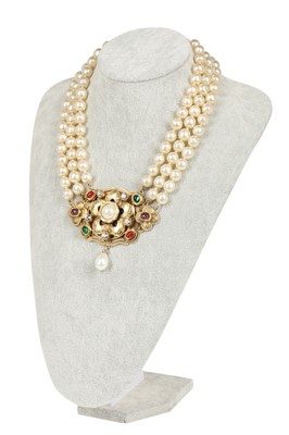 Lot 13 - A fine Chanel three-strand 'pearl' necklace with bejewelled gilt plaquette, 1971-1981