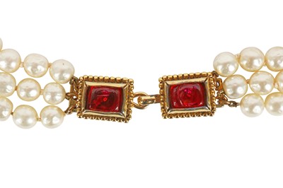 Lot 13 - A fine Chanel three-strand 'pearl' necklace with bejewelled gilt plaquette, 1971-1981