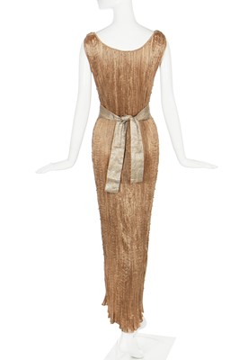 Lot 58 - A Mariano Fortuny pale-gold pleated silk Delphos gown, 1920-30