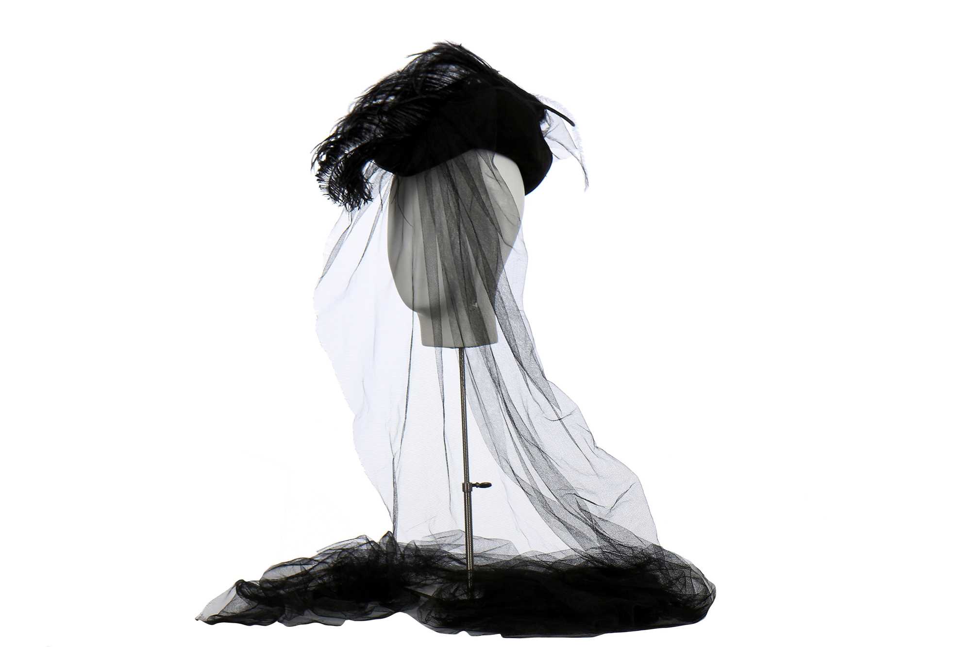 Lot 235 - A Vivienne Westwood black velvet hat with tulle veil to rear, circa 2008