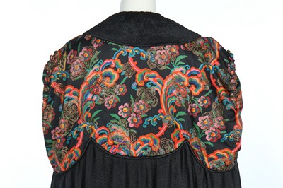 Lot 357 - A black satin and printed lamé opera cape, circa 1920