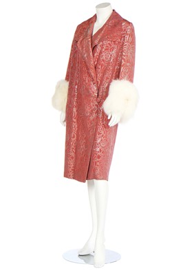 Lot 342 - An evening coat of coral and silver brocade woven in art deco floral motif, circa 1930