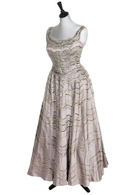 Lot 292 - Gracie Fields' embellished silver satin evening gown, 1956