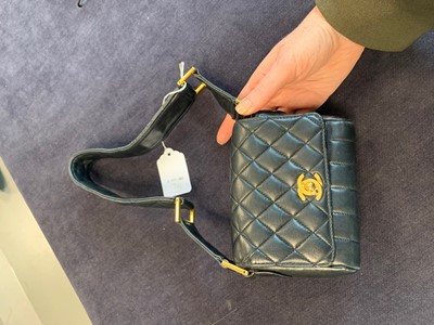 Lot 3 - A Chanel mini quilted navy lambskin leather flap bag, 1980s-early 1990s